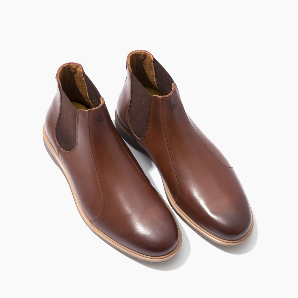 Stylish brown Chelsea boots with tan soles.