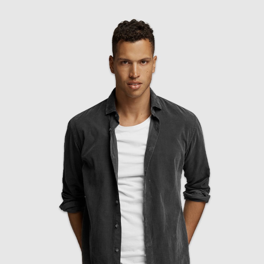 Man wears dark casual shirt.