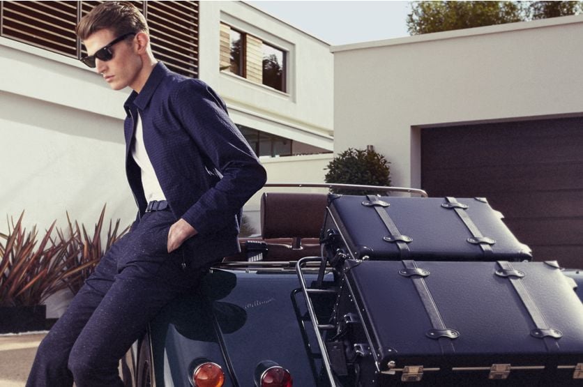 Man in suit, sunglasses by vintage car: Dress like a Londoner.