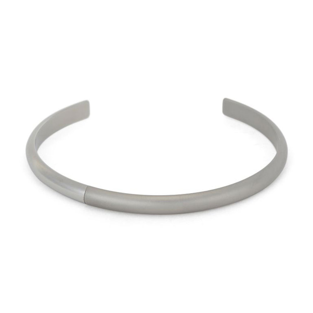 Men's polished silver cuff bracelet on display.