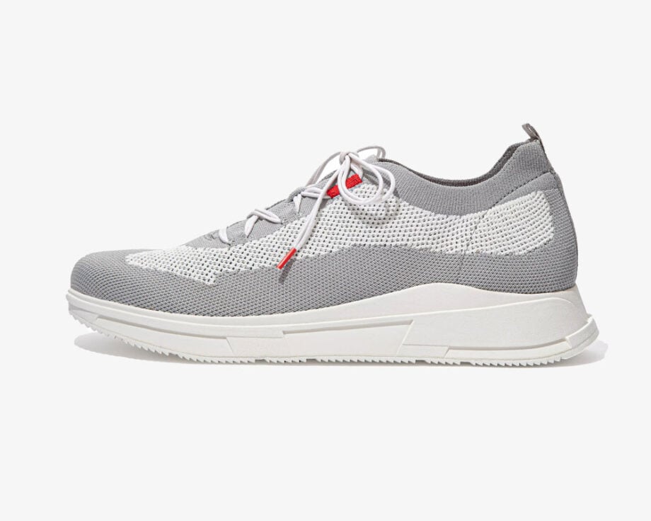 Gray and white athletic shoes with red accents.