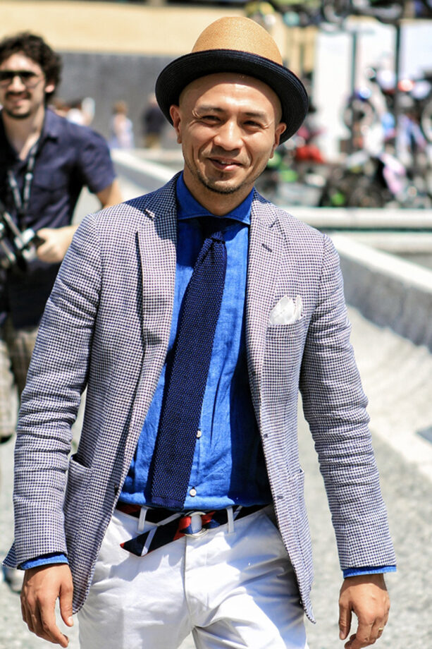 Dapper man stands; tie tutorial.