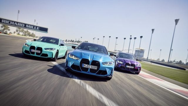 Three sports cars, including a BMW M3, race.