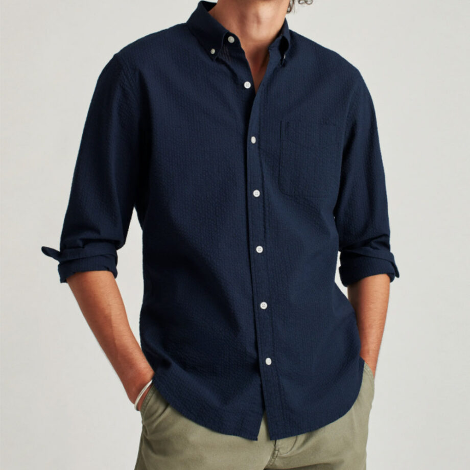 Man wears dark blue shirt, olive pants.