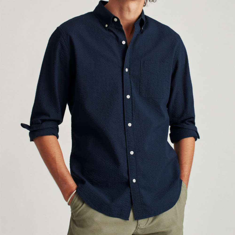 Man wears dark blue shirt, olive pants.