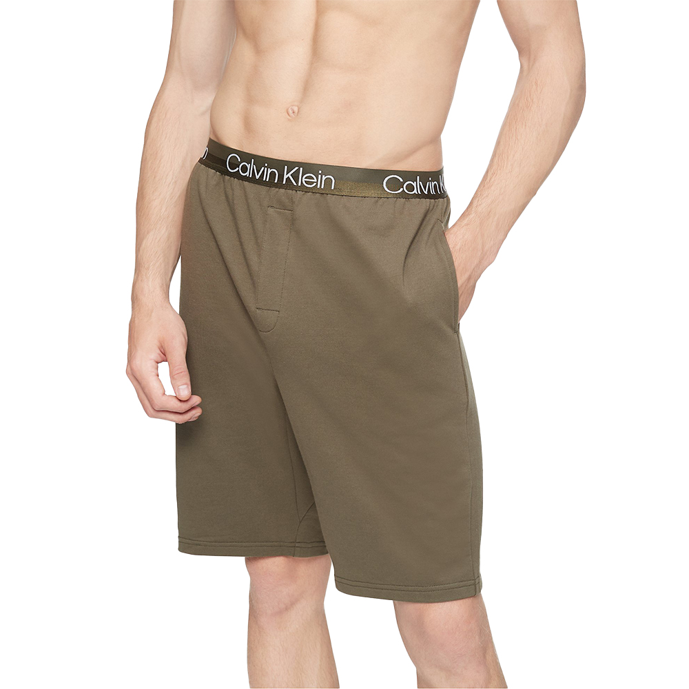 Person wears Calvin Klein olive lounge shorts.