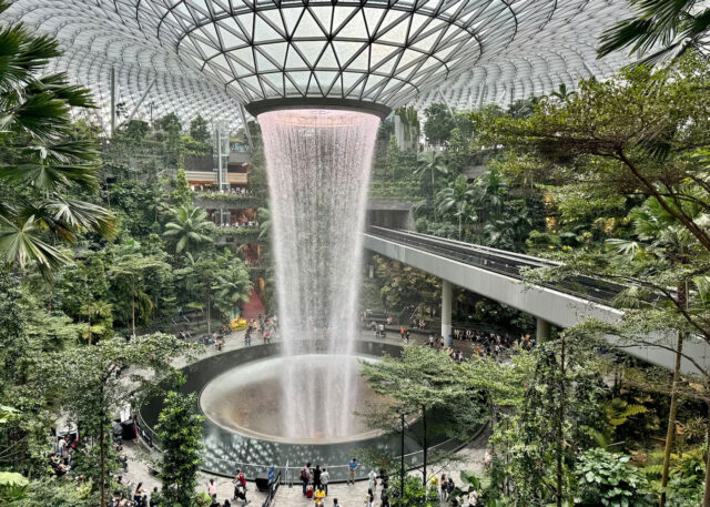 Changi Airport indoor waterfall with lush greenery.