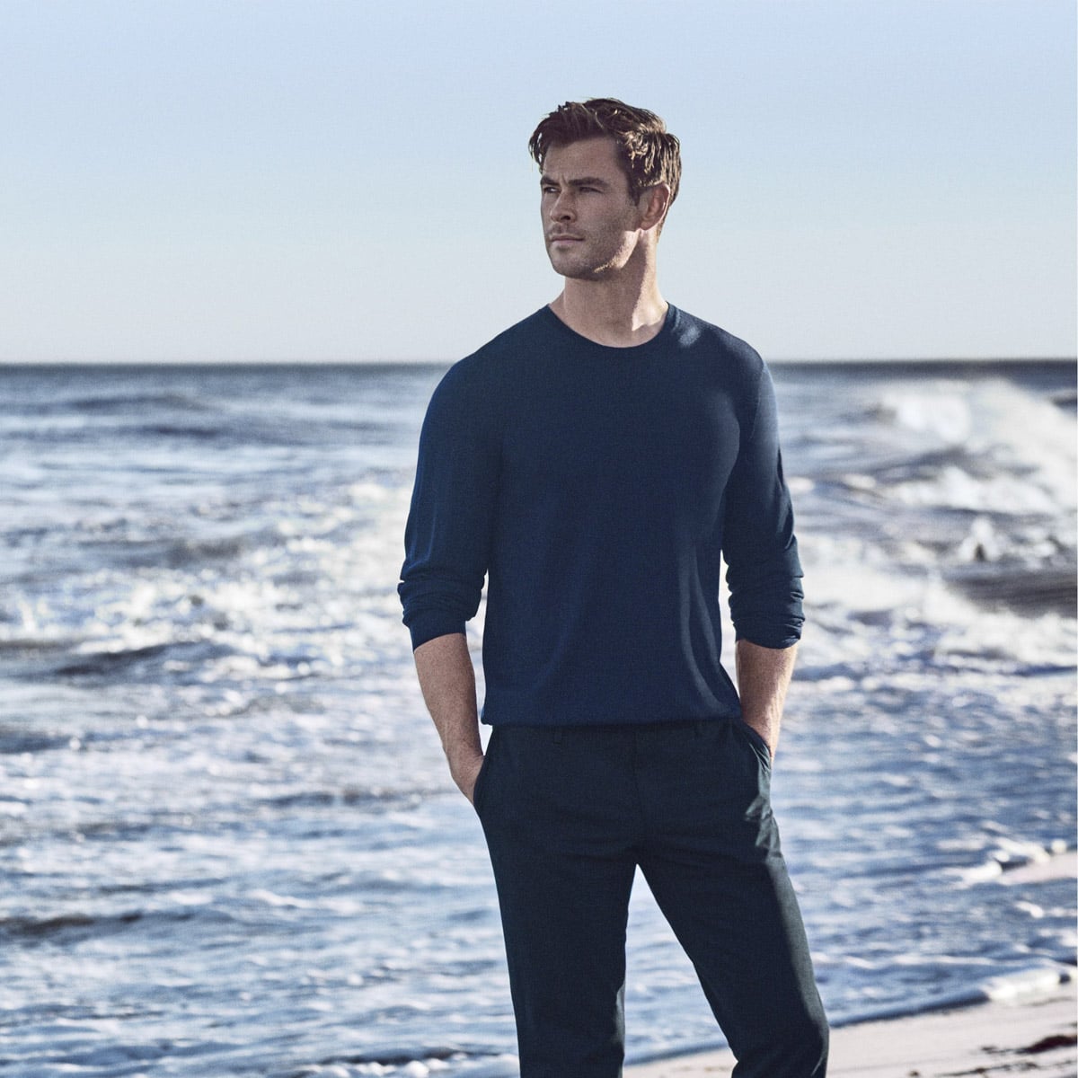 Chris Hemsworth-inspired man on beach.