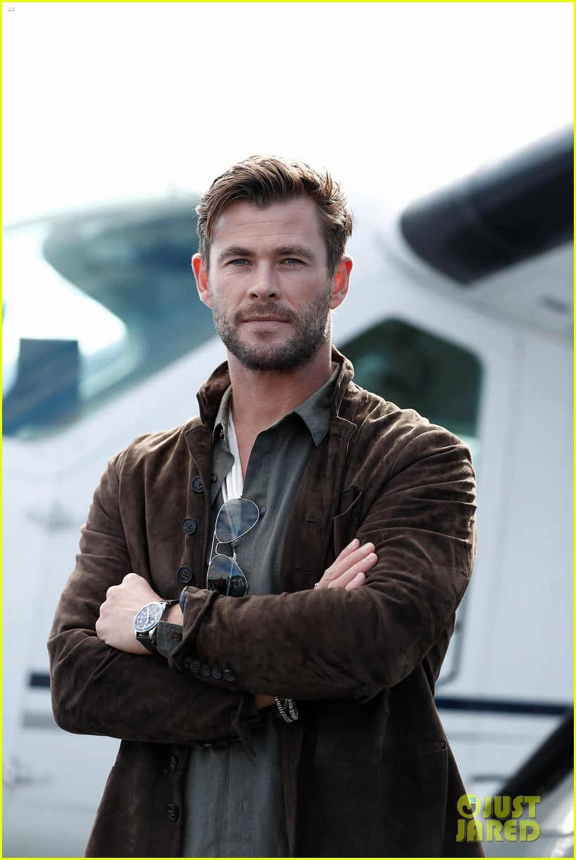 Chris Hemsworth vibes, airplane backdrop.
