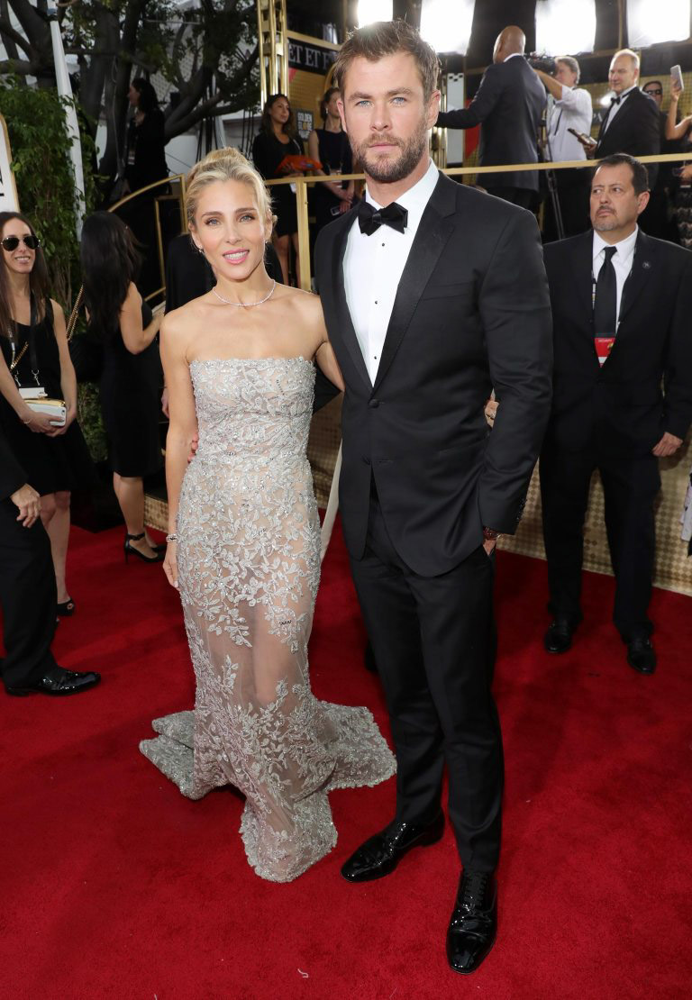 Couple on red carpet, glamorous.