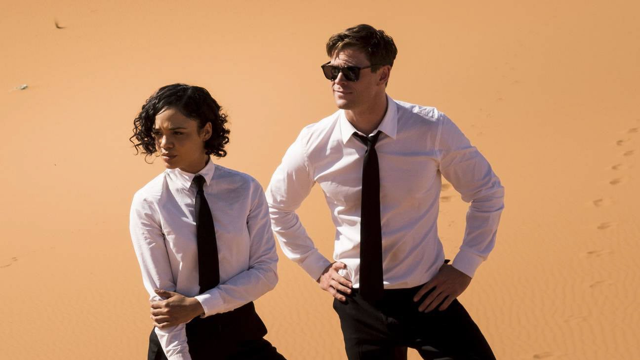 Two stylish people in desert.