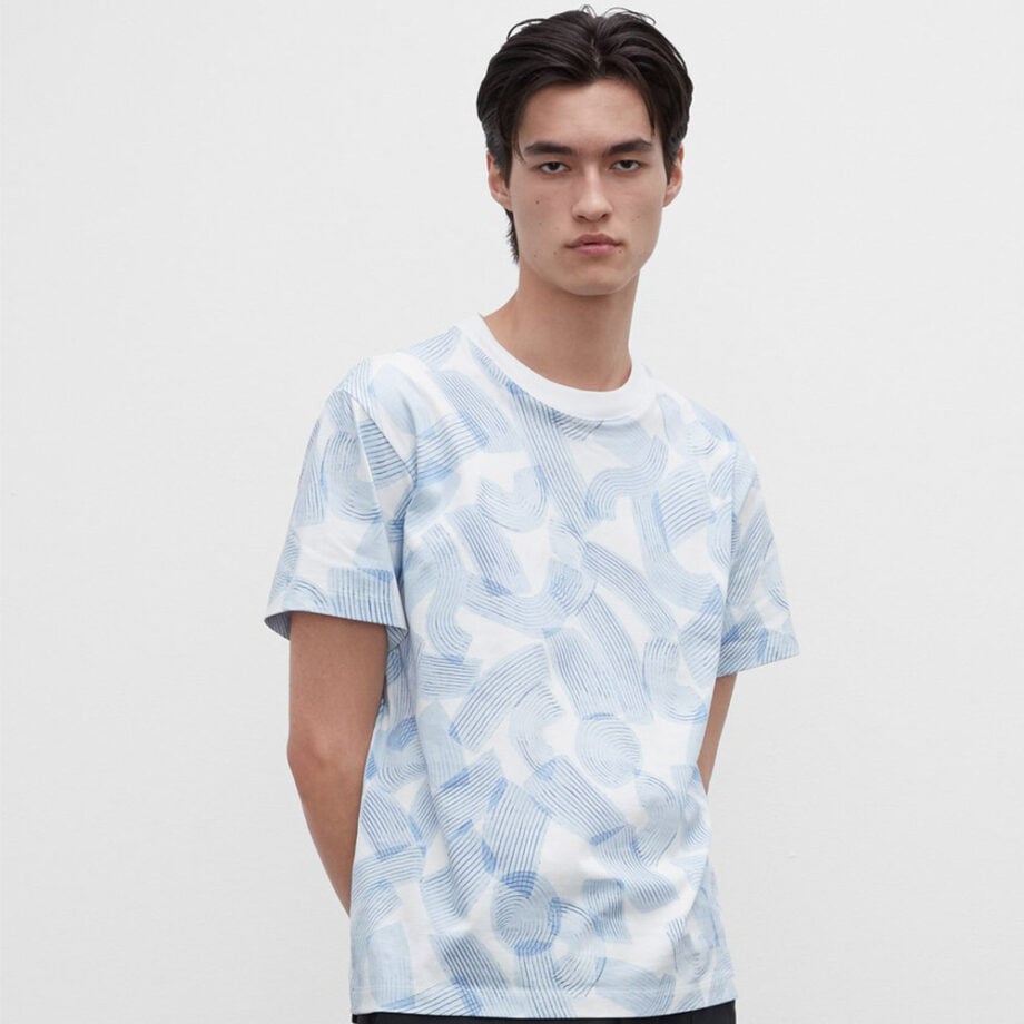 Dark-haired person wearing printed t-shirt.