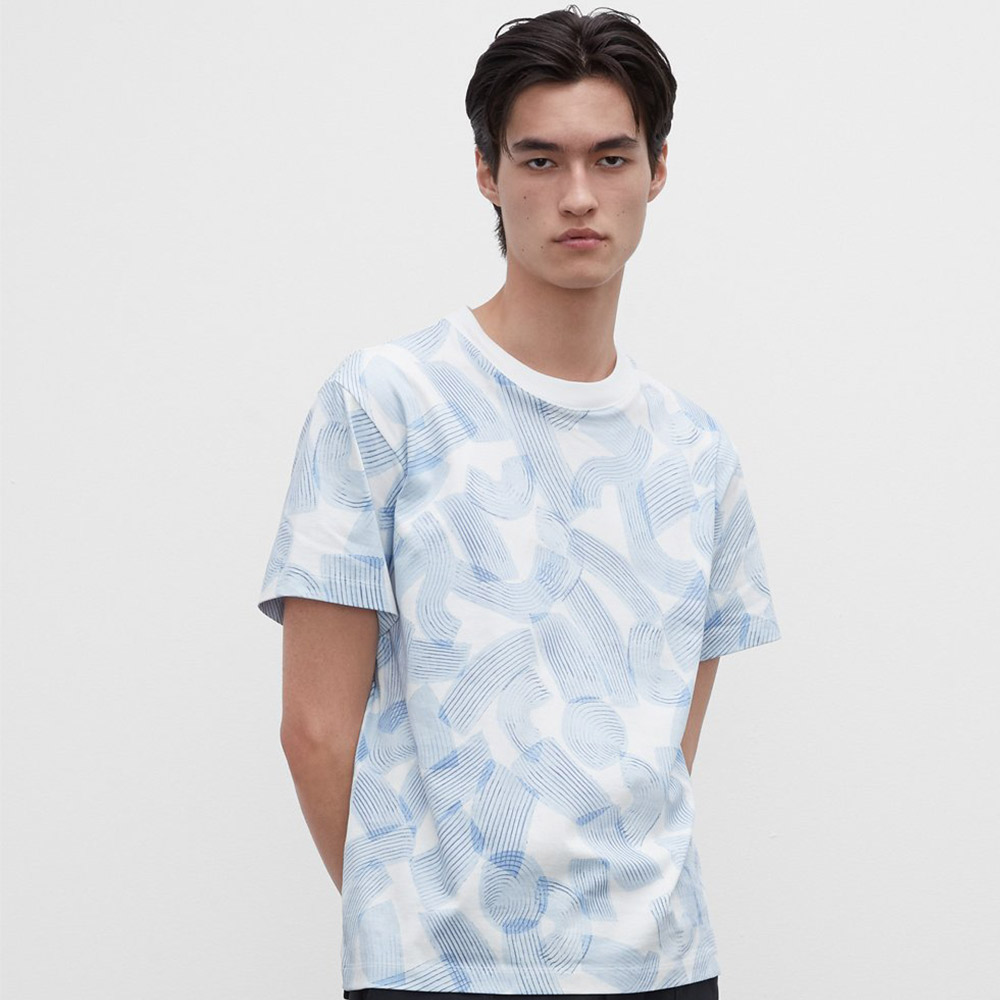 Dark-haired person wearing printed t-shirt.