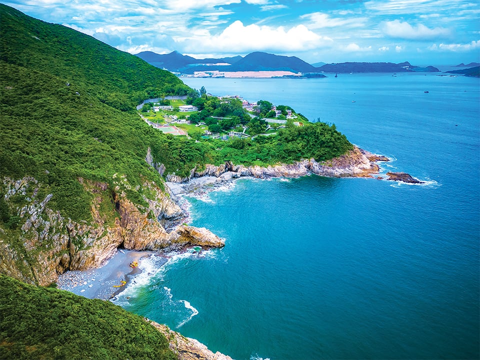 Coastal road between Shek O and Big Wave Bay winding through green hills.