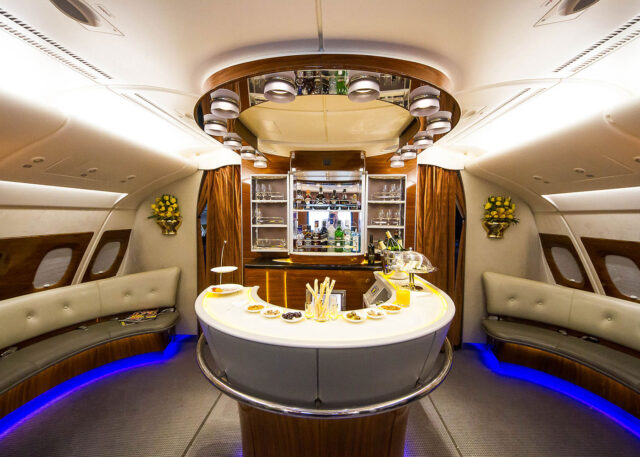 Luxurious airplane cabin with bar and cognac.