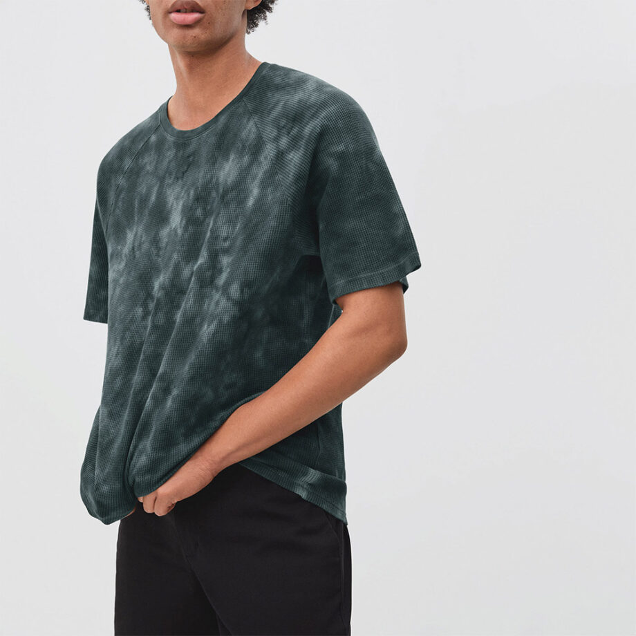 Person in tie-dye t-shirt and black pants.