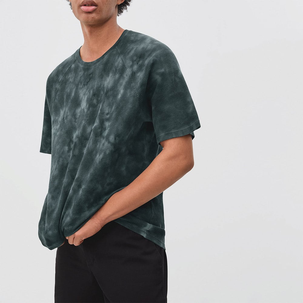 Person in tie-dye t-shirt and black pants.