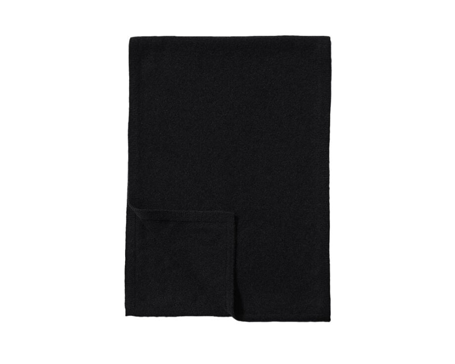 Black men's scarf on white backdrop, wintery warmth.