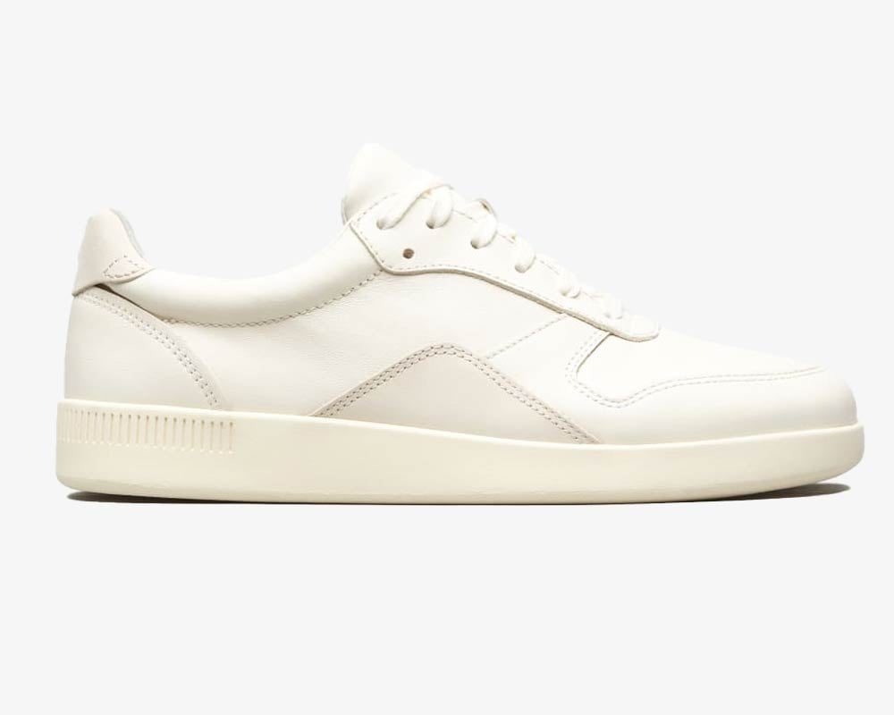 Men's white low-top sneakers with textured sole.