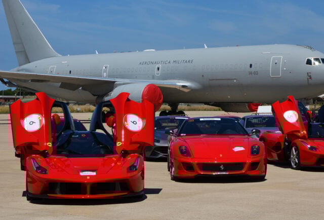 Luxury Ferraris parked by Aeronautica Militare plane.