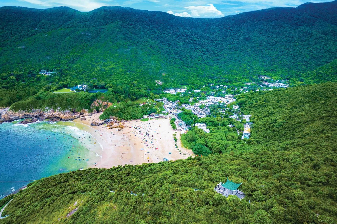 Big Wave Bay with tropical hills behind.