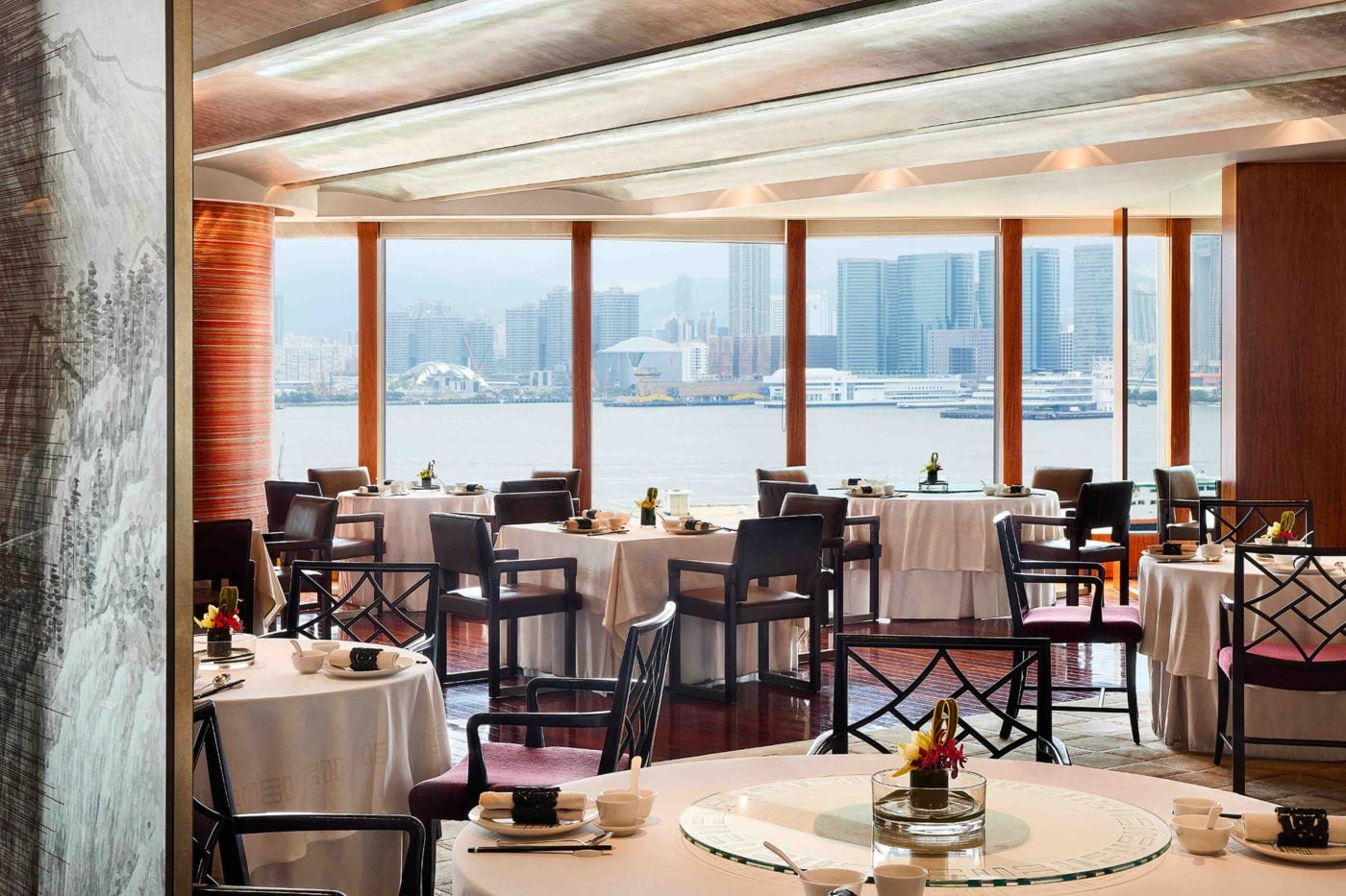 Table at Salisterra with breakfast dishes and panoramic harbour view.