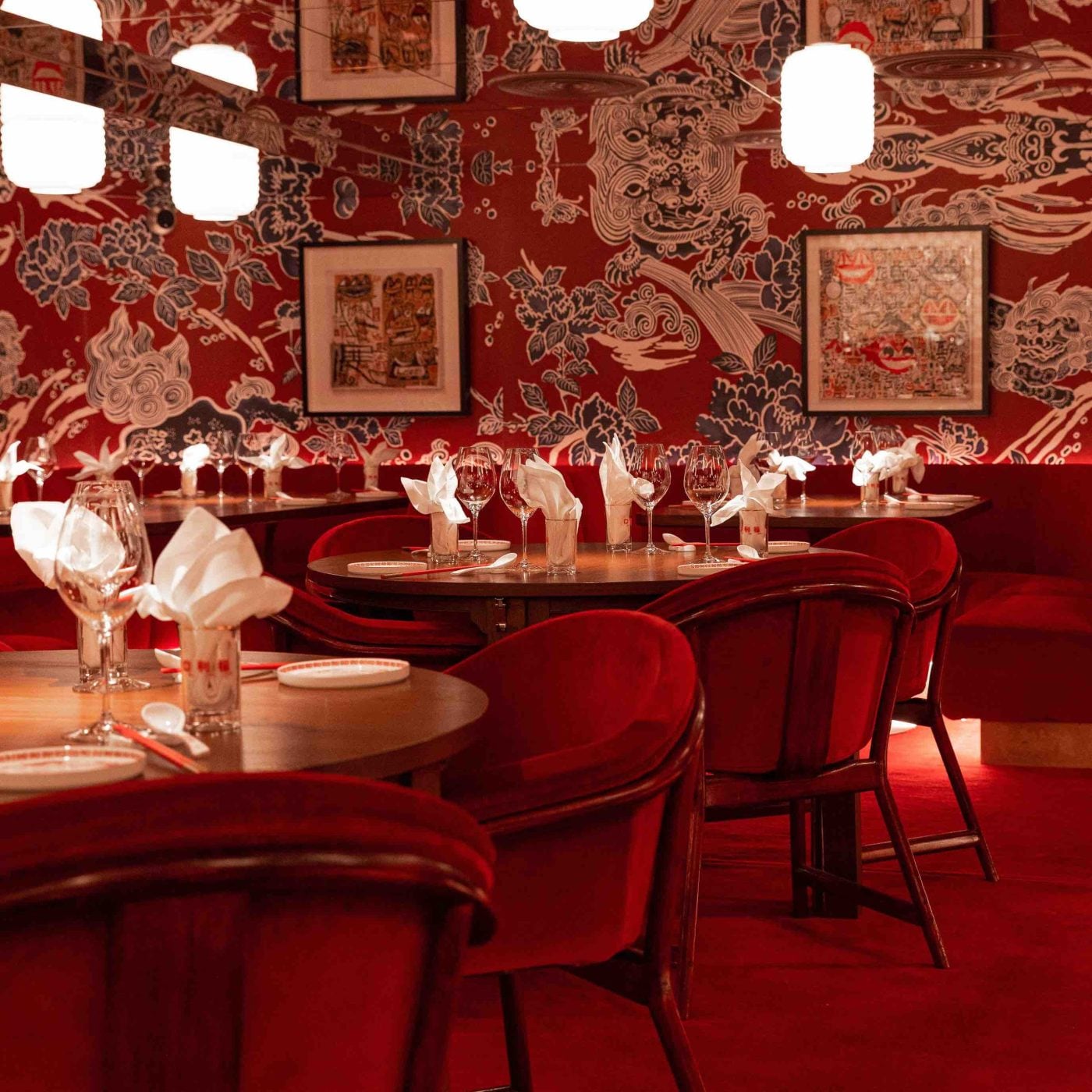 Interior of Ho Lee Fook restaurant in Soho with neon lights and diners.