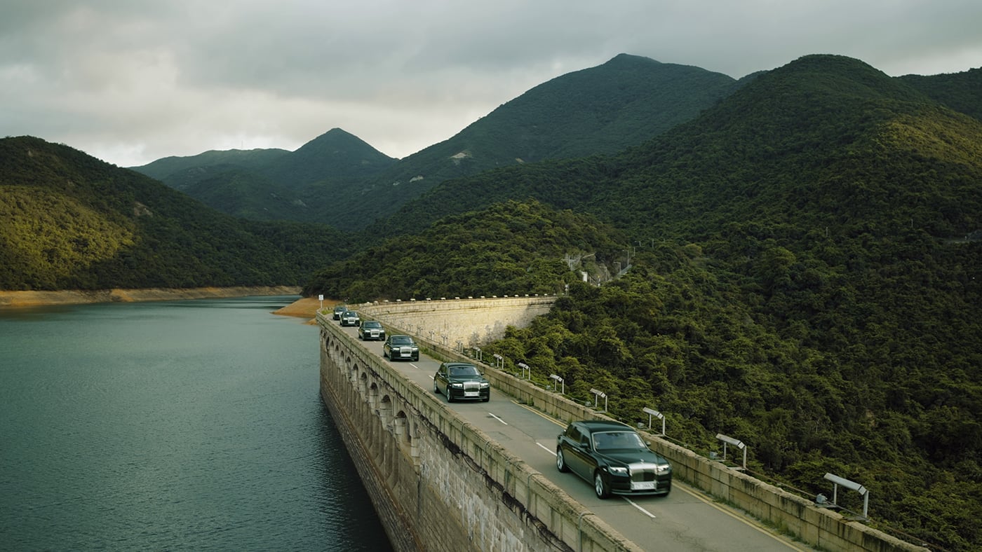 Fleet of green Rolls-Royce Phantoms driving. 