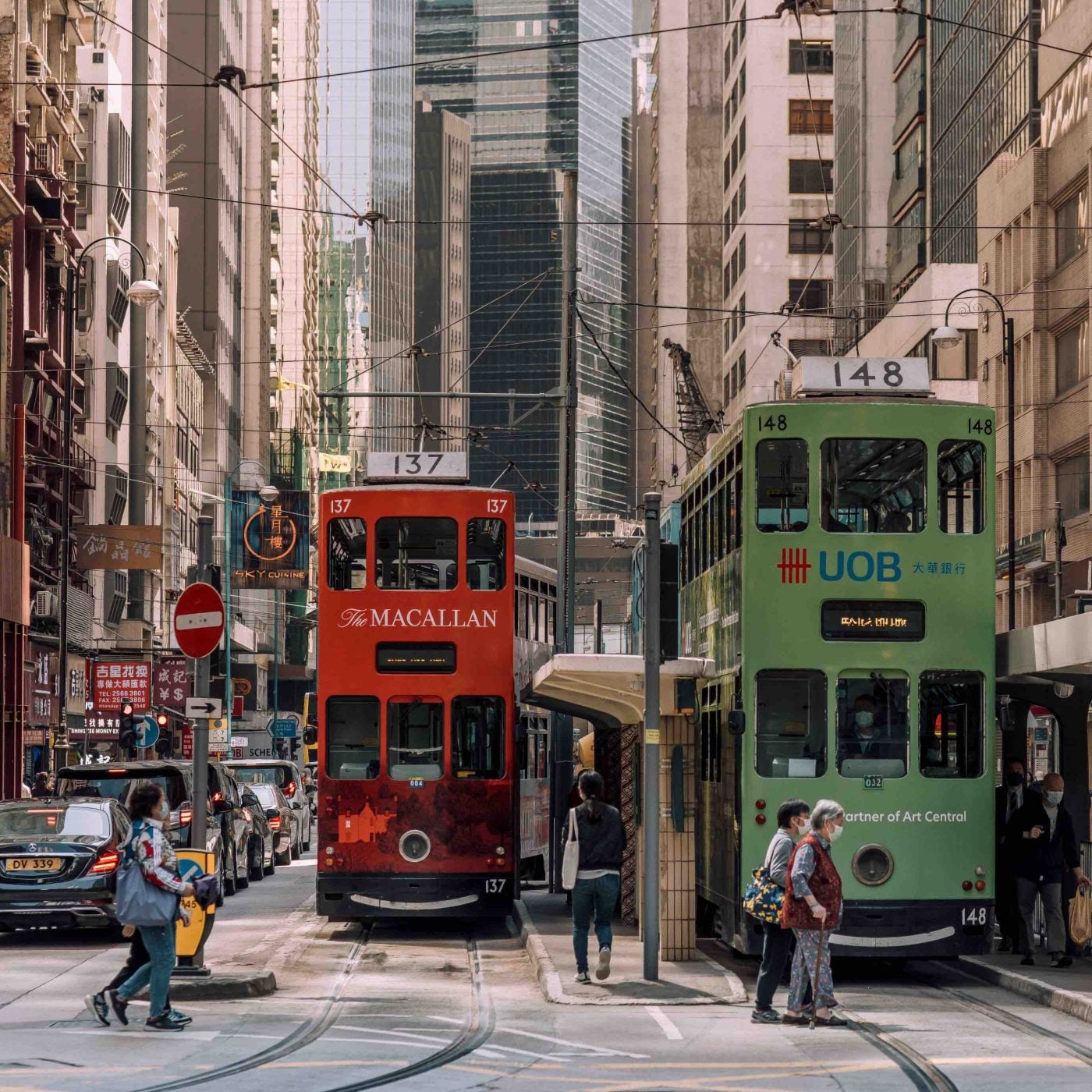Classic green Hong Kong tram moving through Wan Chai streets.