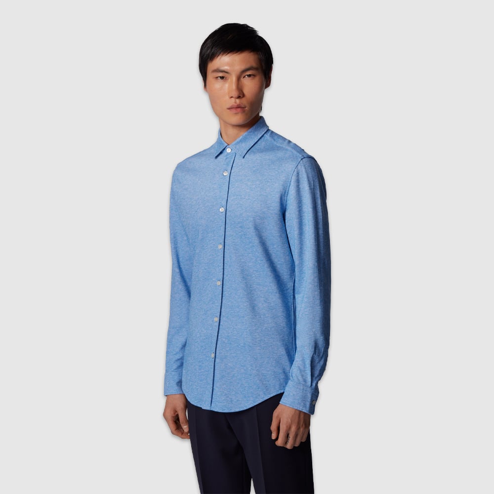 Person in formal light-blue shirt.