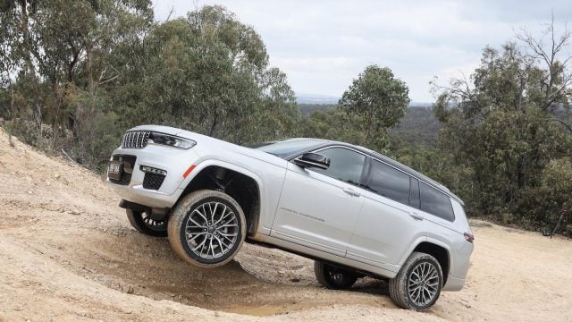 Jeep Grand Cherokee off-roading on rugged trail.