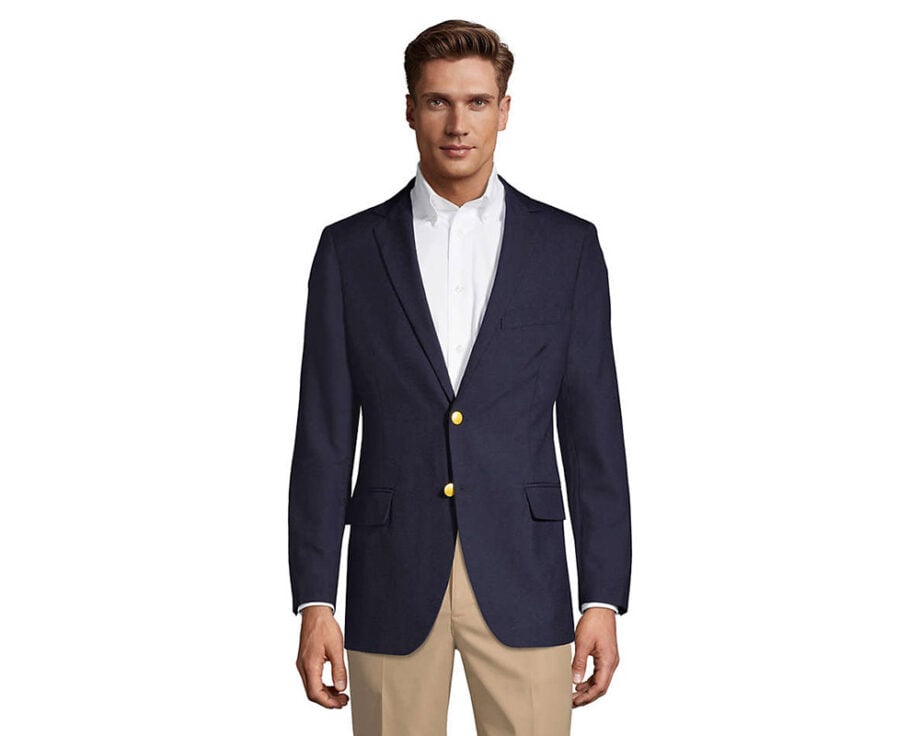 Man in navy blazer, white shirt, beige pants.
