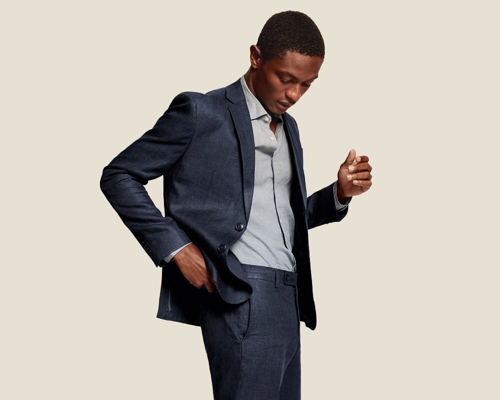 Man in suit embodies workwear brand essence.