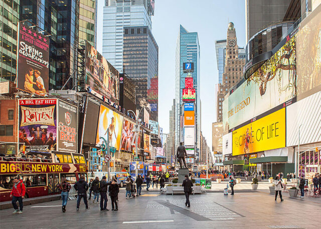 Pedestrians and tour bus in Times Square.