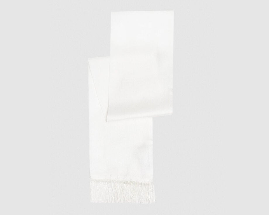 Silk scarf with fringes adds winter elegance.