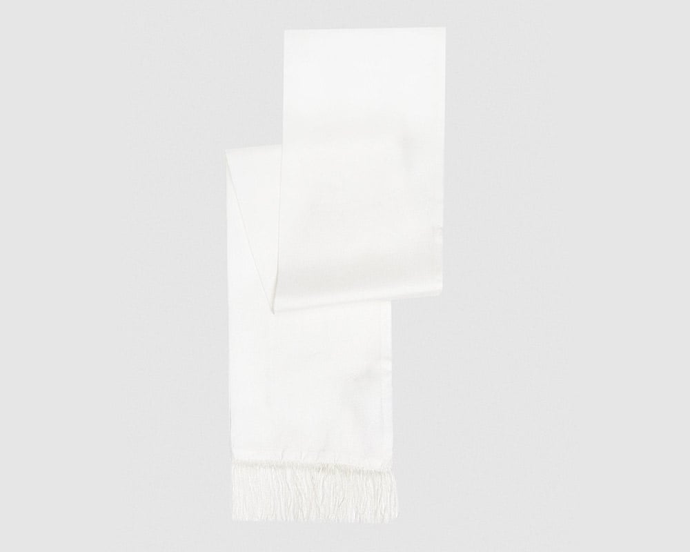 Silk scarf with fringes adds winter elegance.