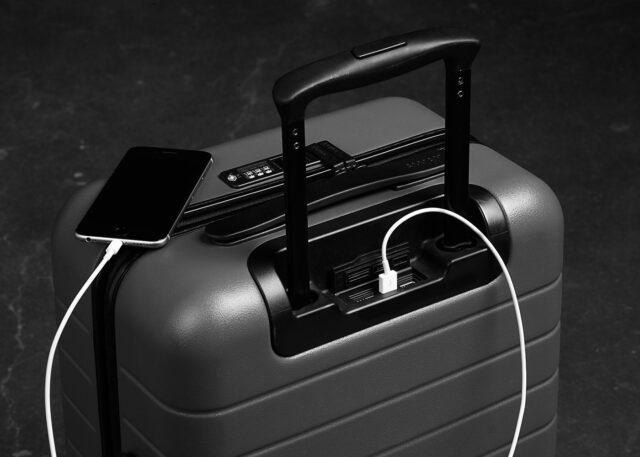 Smart suitcase with a USB port charges smartphone.