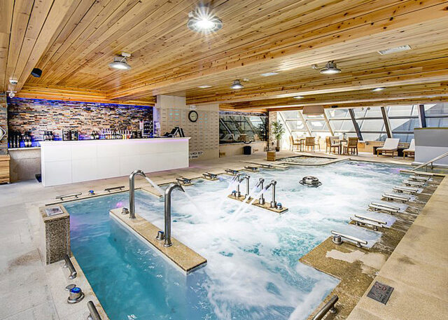 NYC-style indoor pool with jacuzzi and bar.