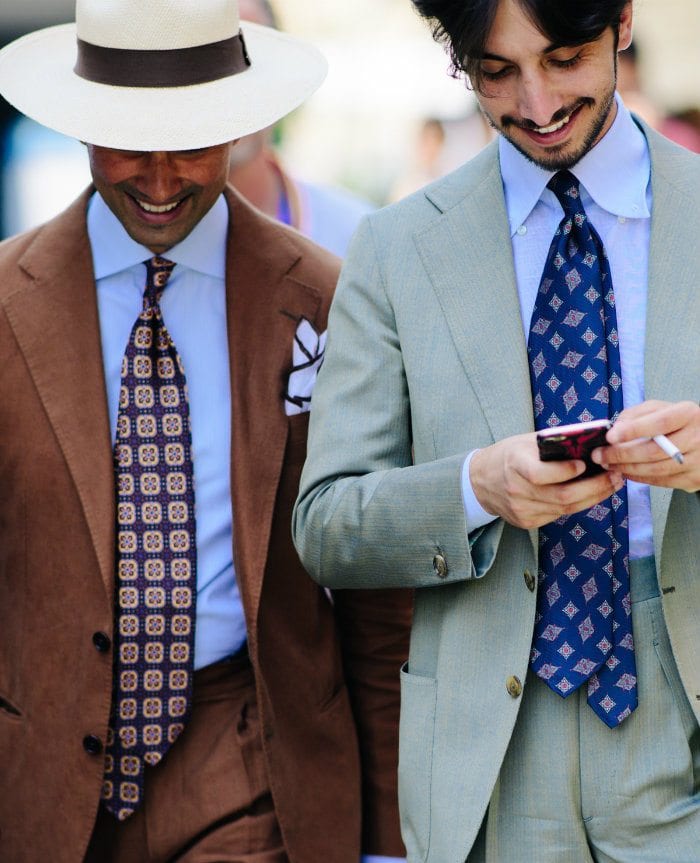 Stylish men in suits outdoors.