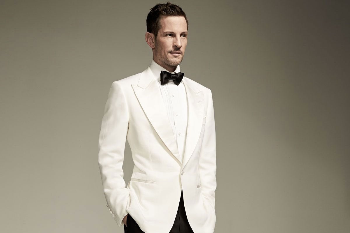 Man in white tuxedo jacket.