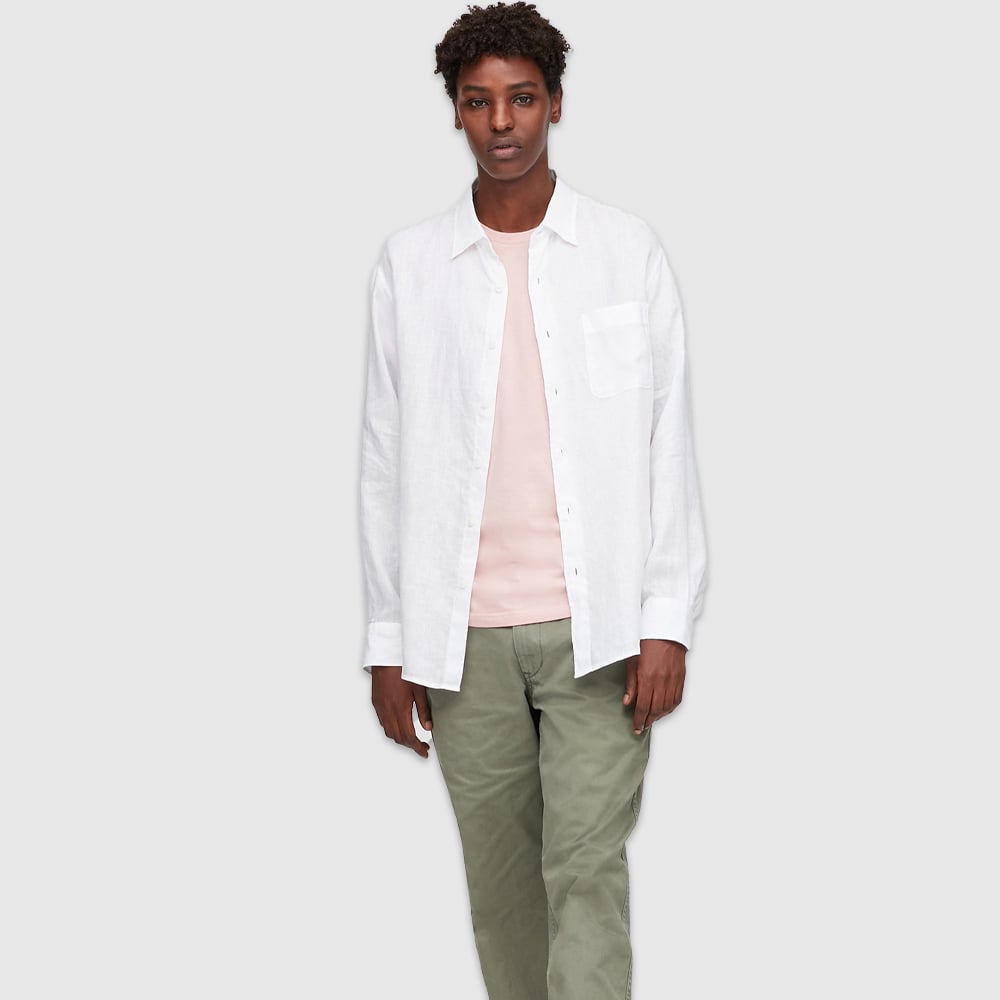 Wearing stylish white button-up shirt.