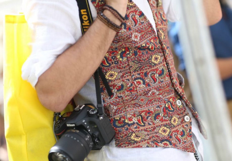 Colorful vest, yellow bag, Nikon.