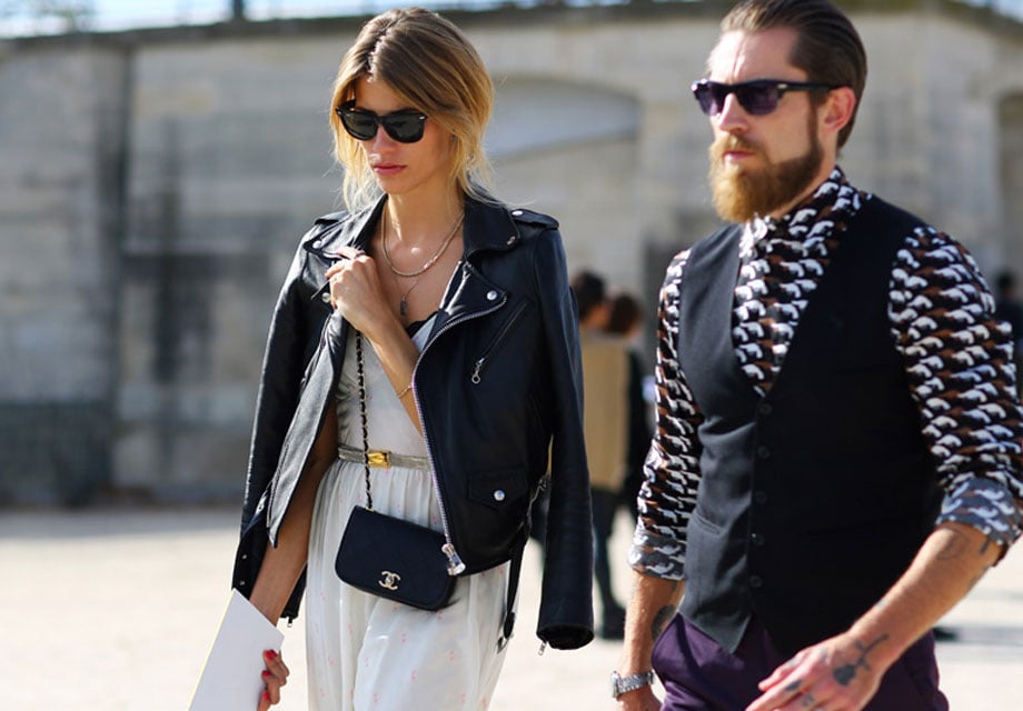 Fashionable couple walks outdoors.