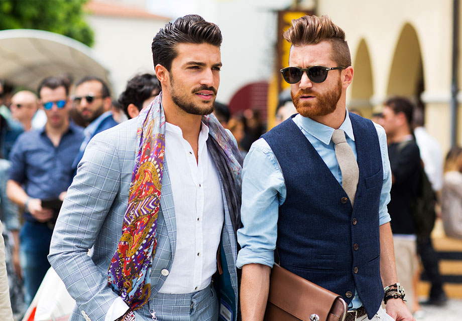Two stylish men outdoors fashionably.